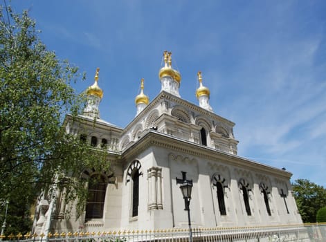 Four golden cupolas of russian eastern orthodox church by beautiful weather in Geneva, Switzerland.