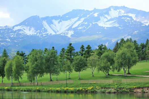 Long lake, trees at the golf place and mountain at Crans Montana, Switzerland