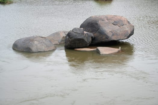 Rocks of myriad shapes amidst river water