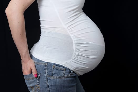 details of side view of a belly of pregnant woman