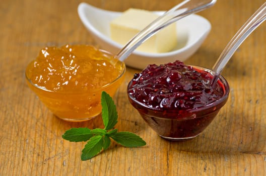 Jam with stevia leaves on wooden board