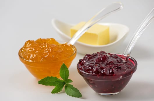 Jam with stevia leaves on white background