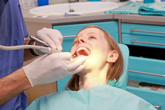 Young bloonde girl in dentist office chair