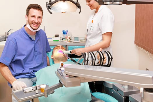 Smiley doctor and patient in dentist office