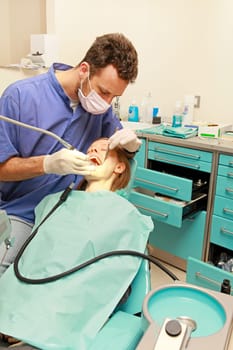 Blonde girl in chair at dentist office
