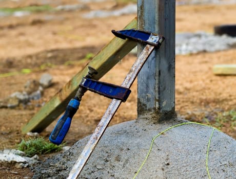 building site concrete footings steel stump and F clamp