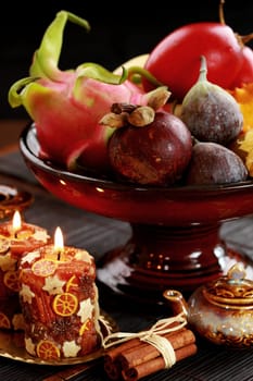 Still life with exotic fruits - mangosteen, fig, dragon fruit, horned melon, tamarillo