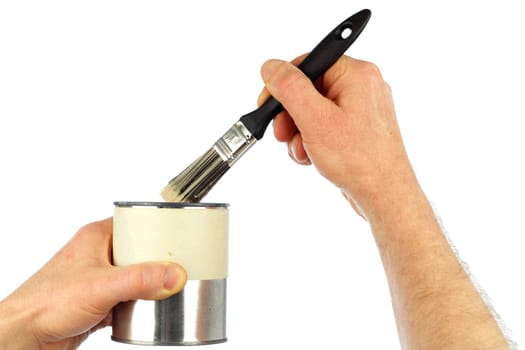 Close up of a hand dipping a small paint brush in a small can of touch up paint being held by the other hand.