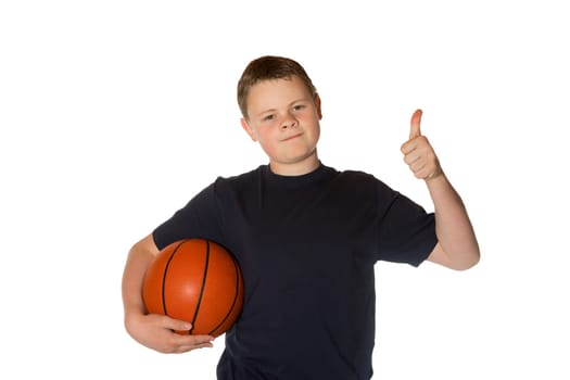 Young man holding a basketball giving a thumbs up of success and approval isolated on white