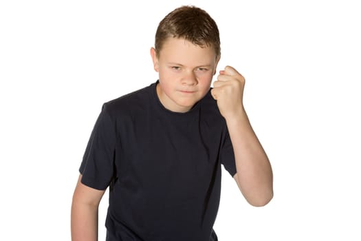 Angry casual young man in a black t-shirt with glaring eyes shaking his fist at the camera isolated on white