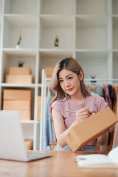 Asian female business owner handles delivery of orders to customers.