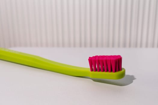 Closeup Big Tooth Brush Lying on White Table, Sink in Bathroom. Daily Routine, Hygiene. Copy Space for Text, Horizontal Plane. Dentistry. High quality photo