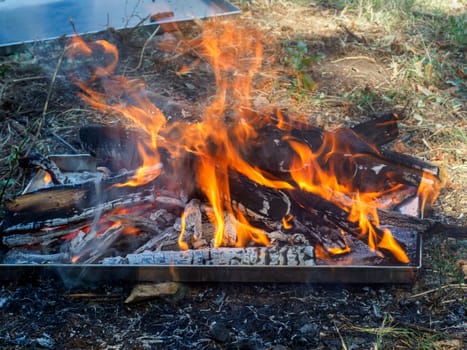 burning wood for organic charcoal produce for grilling meat outdoors