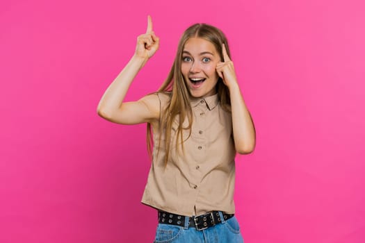 Eureka. Inspired young woman pointing finger up with open mouth, having good idea plan startup, showing inspiration motivation gesture, problem solution. Pretty girl isolated on pink background