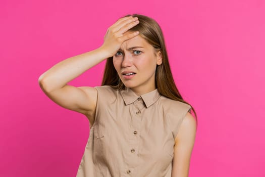 Face palm. Shame on you. Upset Caucasian young woman making face palm gesture, feeling bored, disappointed in result, bad news, sorrowful. Unhappy girl isolated on pink studio background indoors