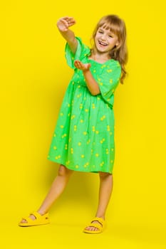 Child girl kid showing wasting, throwing money around, more tips, big profit, winning lottery jackpot, successful shopping payment purchase, cashback. Preteen children on yellow background. Vertical