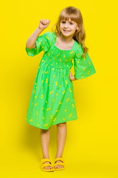 Knock-knock who is there. Confused young blonde child girl kid knocking door gesture asking who is at home, feeling embarrassed, no idea, being clueless uncertain. Little preteen children. Vertical
