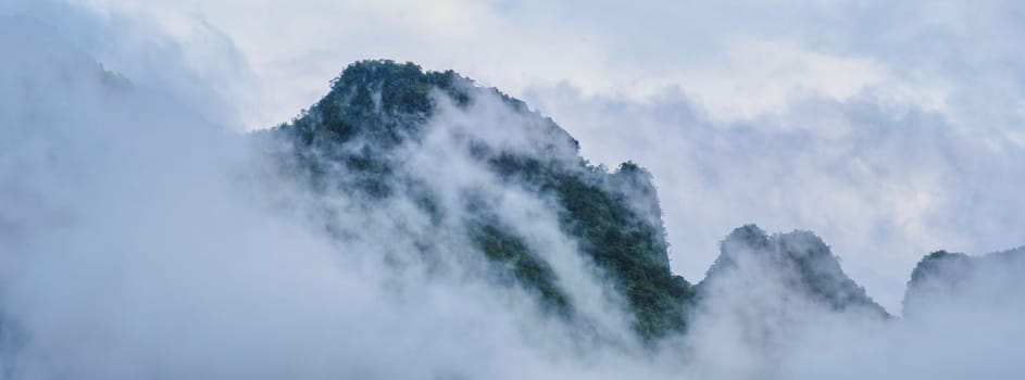 Mountain peak with fog and mist at Doi Luang Chiang Dao mountain hills in Chiang Mai, Thailand. Nature landscape in travel trips and vacations. Doi Lhung Chiang Dao Viewpoint with mist and fog