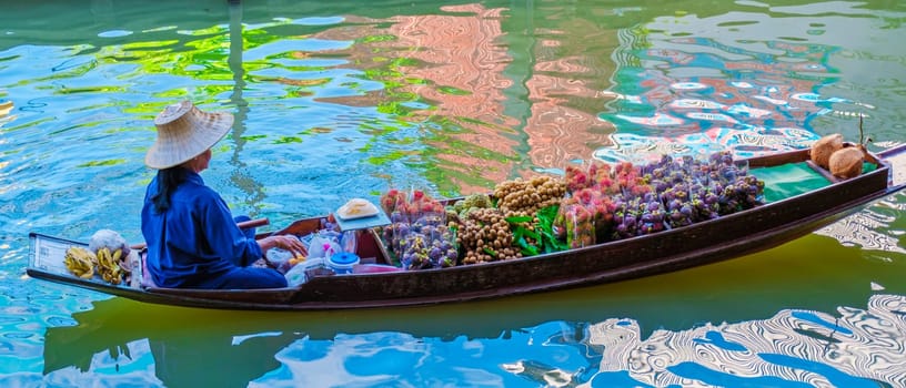 August 2023, market stall holders in small boats selling local fruits and vegetables, Damnoen Saduak Floating Market, Thailand