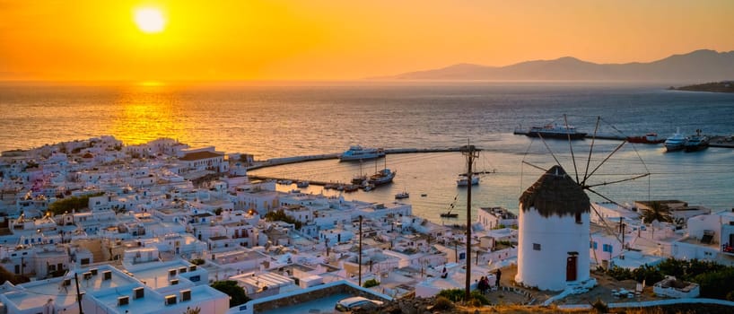 Sunset on the hills of Mykonos Greek village in Greece, the colorful old town of Mikonos village with historical windmills at sunset