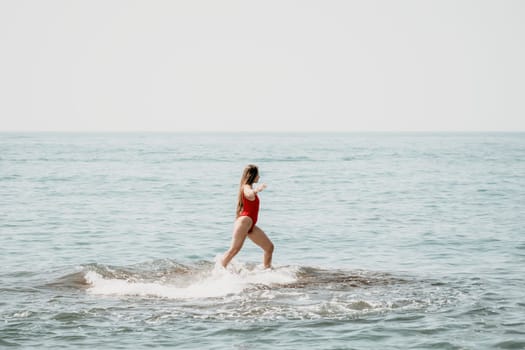 Woman sea yoga. Back view of free calm happy satisfied woman with long hair standing on top rock with yoga position against of sky by the sea. Healthy lifestyle outdoors in nature, fitness concept.