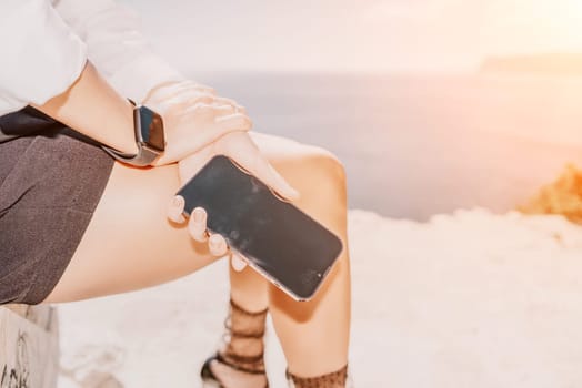 Happy girl doing yoga with laptop working at the beach. beautiful and calm business woman sitting with a laptop in a summer cafe in the lotus position meditating and relaxing. freelance girl remote work beach paradise