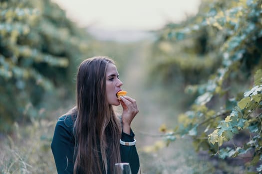 Picnic and wine tasting at sunset in the hills of Italy, Tuscany. Vineyards and open nature in the summer. Romantic dinner, fruit and wine.