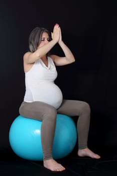 details of relaxation exercise for a pregnant woman isolated on black