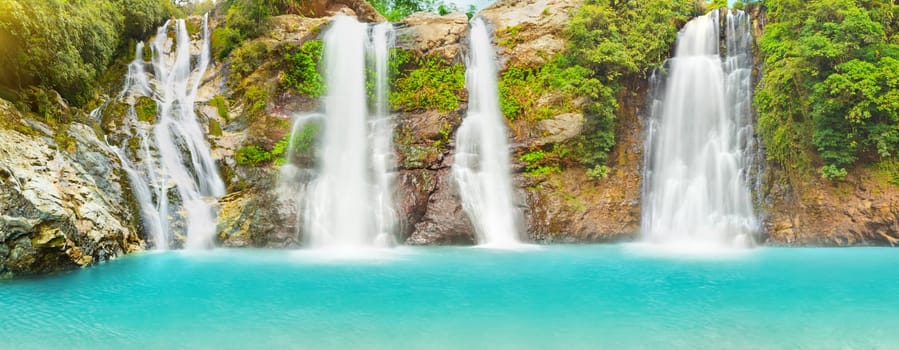 Beautiful panorama of waterfalls at summer day