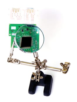 Checking and repairing a green pcb board, isolated on white background
