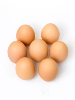 Seven fresh eggs in a round shape, isolates on white background