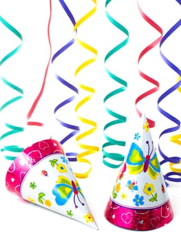 Hats and serpentina (ribbons) for kid party, isolated on white background