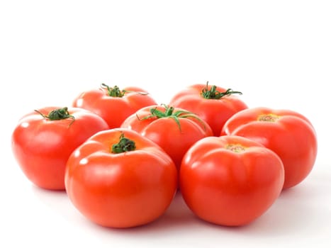Seven fresh tomatoes in a circle isolated on white background