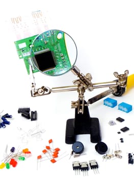 Repairing a green pcb board and electronic components, isolated on white background
