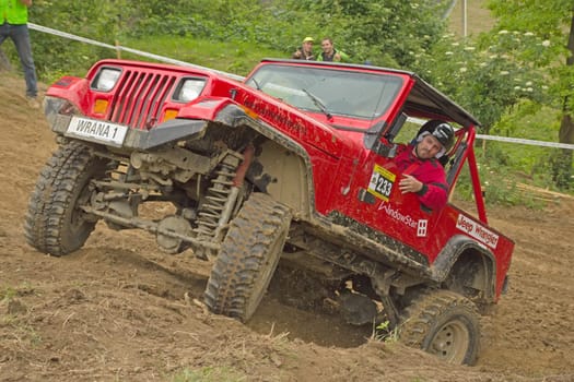 MOHELNICE, CZECH REPUBLIC - JUNE 10. Unidentified racer at red off-road car leaves steep slope in the "SHOCK CUP Trial 2012"" on June 10, 2012 in the town of Mohelnice, Czech Republic."