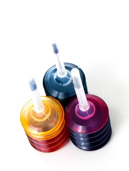 Red, yellow and blue botles with colors for refilling inkjet printer