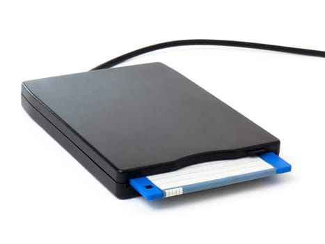 A black external usb floppy disk drive with a blue disk inside, isolated on white background