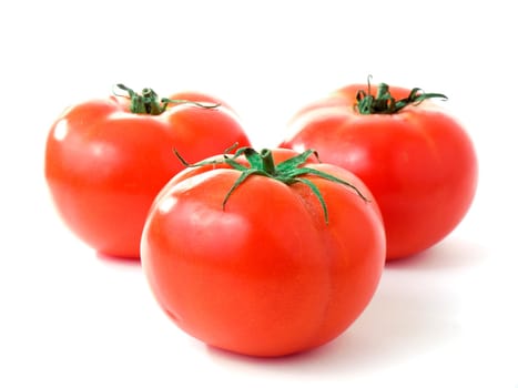 Three fresh red tomatoes isolated on white background