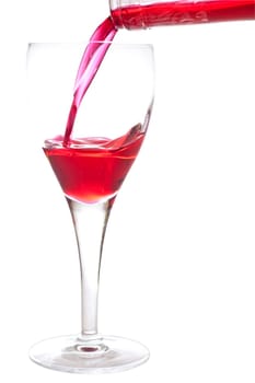 Filling a glass with red cherry liquer, drink, on white background