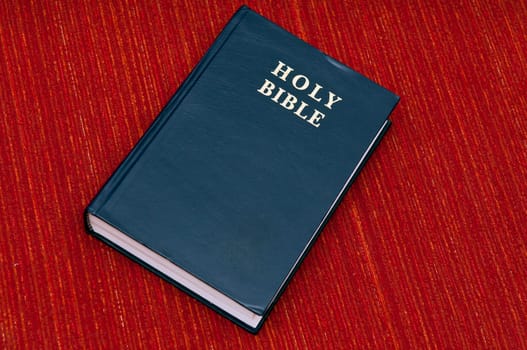 An old bible isolated on  red textured background