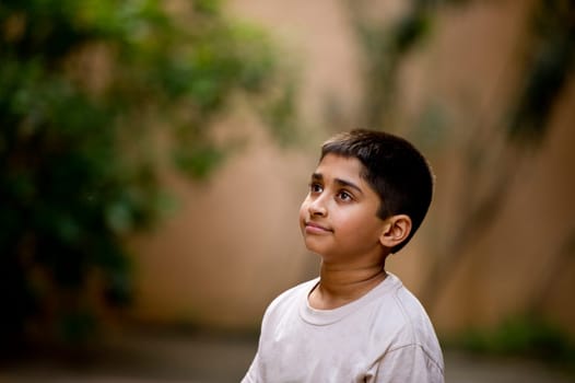 an young handsome Indian kid day dreaming