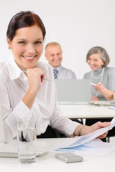 Young executive woman review charts during meeting with team colleagues
