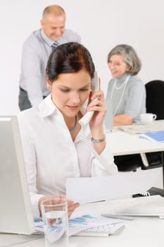 Business team pretty businesswoman calling phone happy colleagues around table