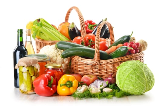 Composition with wicker basket and grocery isolated on white