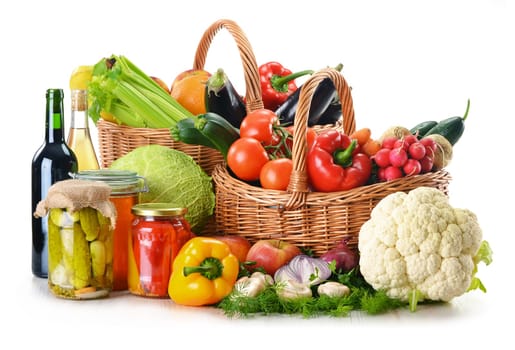 Composition with wicker basket and grocery isolated on white