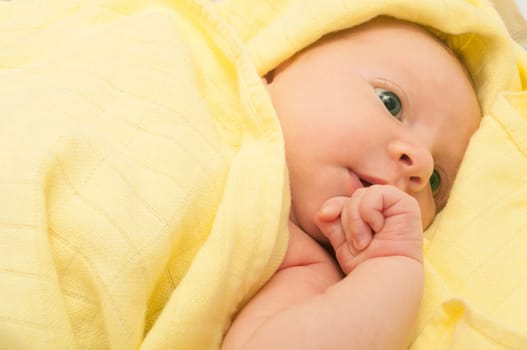 Newborn Baby in the Bed under Yellow Blanket