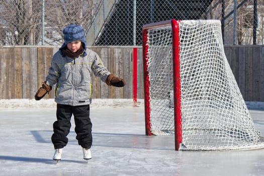 Little girl skating at an outdoor skating rink.