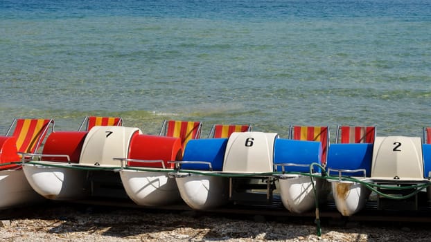 Colorful pedal boats on the beach