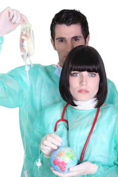 two surgeons auscultating a globe