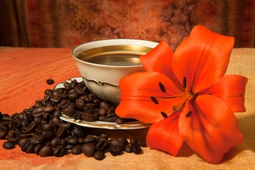 cup with coffee beans and sunflowers on a colored background